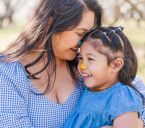 Mother and daughter wearing colorful kid safe sunscreen on their noses